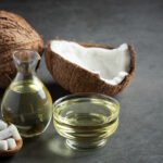a jug of coconut oil whit coconut put on dark background